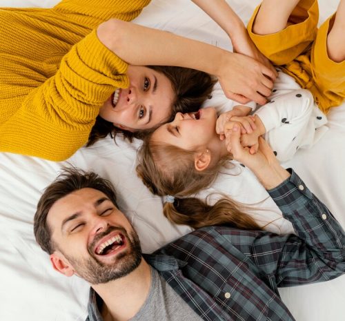 medium-shot-parents-kid-bed-top-view_23-2148861240